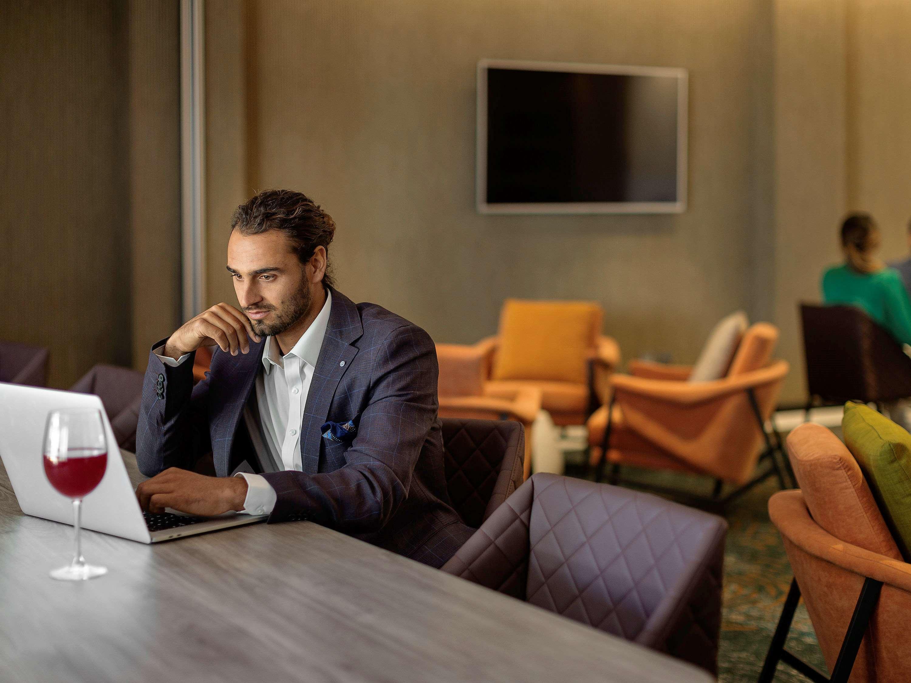 Hotel Pullman Rotorua Exteriér fotografie A man working on a laptop